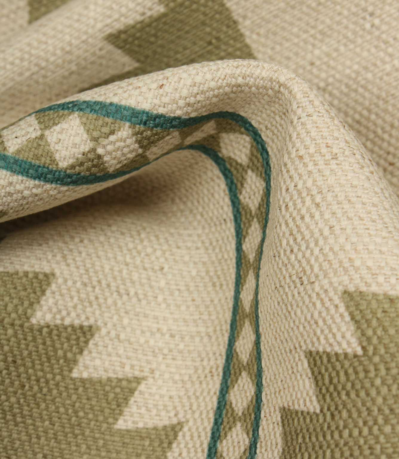 Close-up of a woven fabric with geometric pattern and green thread