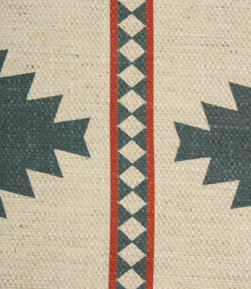 Close-up of cream textured fabric with teal geometric detailing and narrow rust red striped borders showing the woven surface and printed pattern.