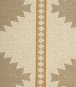 Close-up of textured cream fabric featuring taupe geometric motifs and decorative ochre striped borders with diamond detailing.