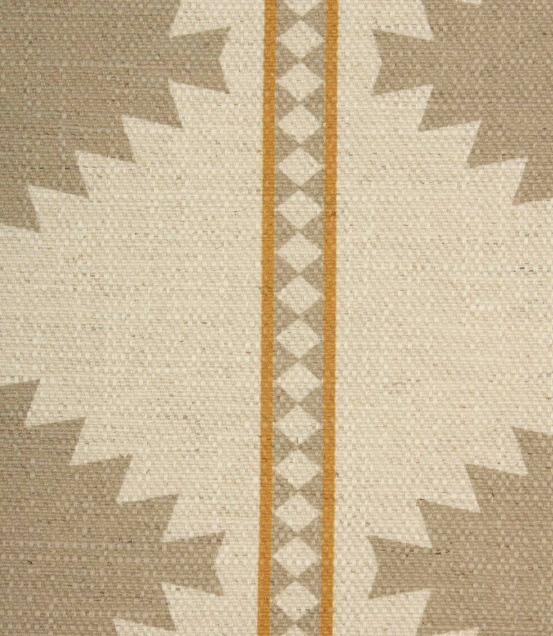 Close-up of textured cream fabric featuring taupe geometric motifs and decorative ochre striped borders with diamond detailing.