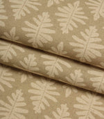 Folded Ashleaf Almond woven fabric highlighting texture and small-scale leaf motif.