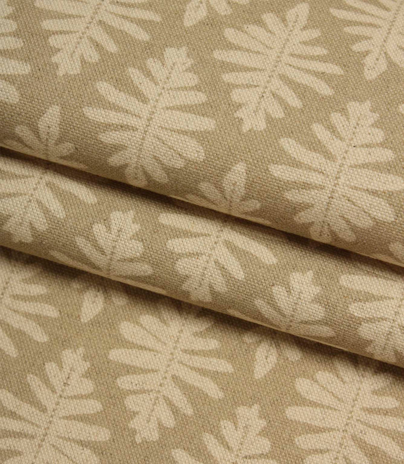 Folded Ashleaf Almond woven fabric highlighting texture and small-scale leaf motif.