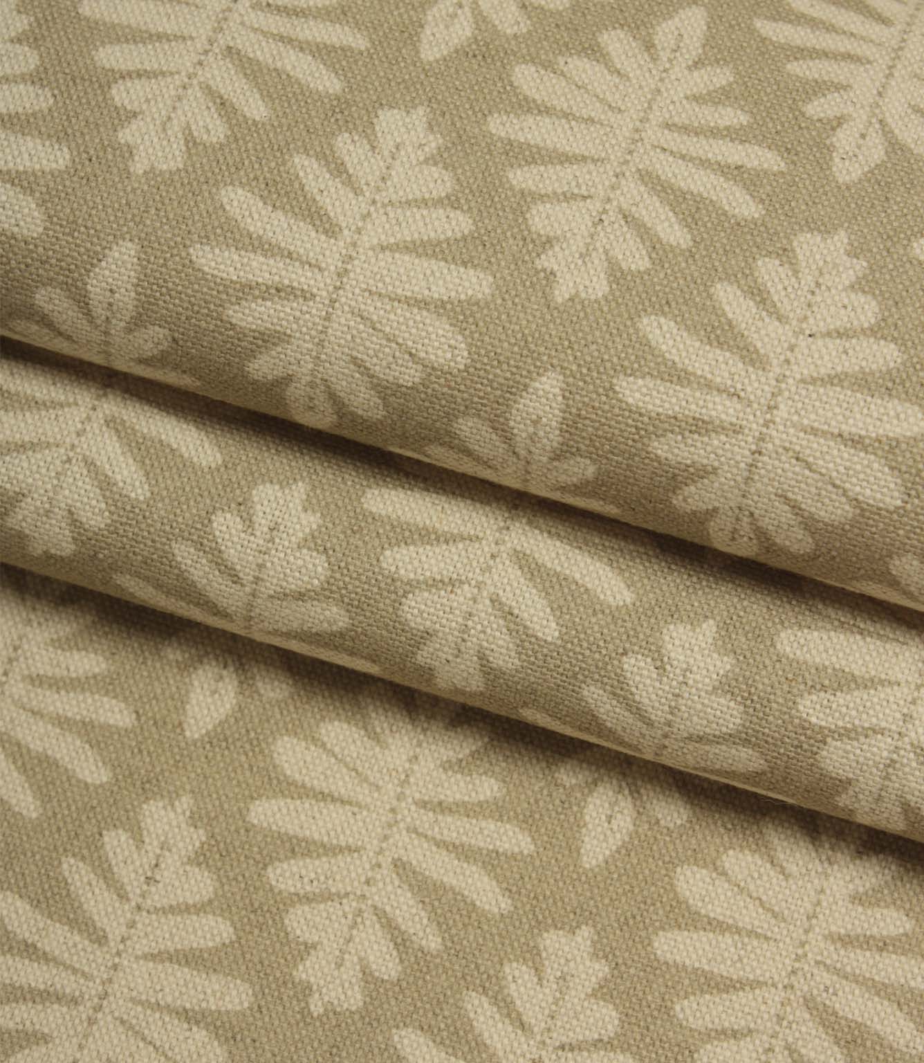 Folded Ashleaf Almond woven fabric highlighting texture and small-scale leaf motif.