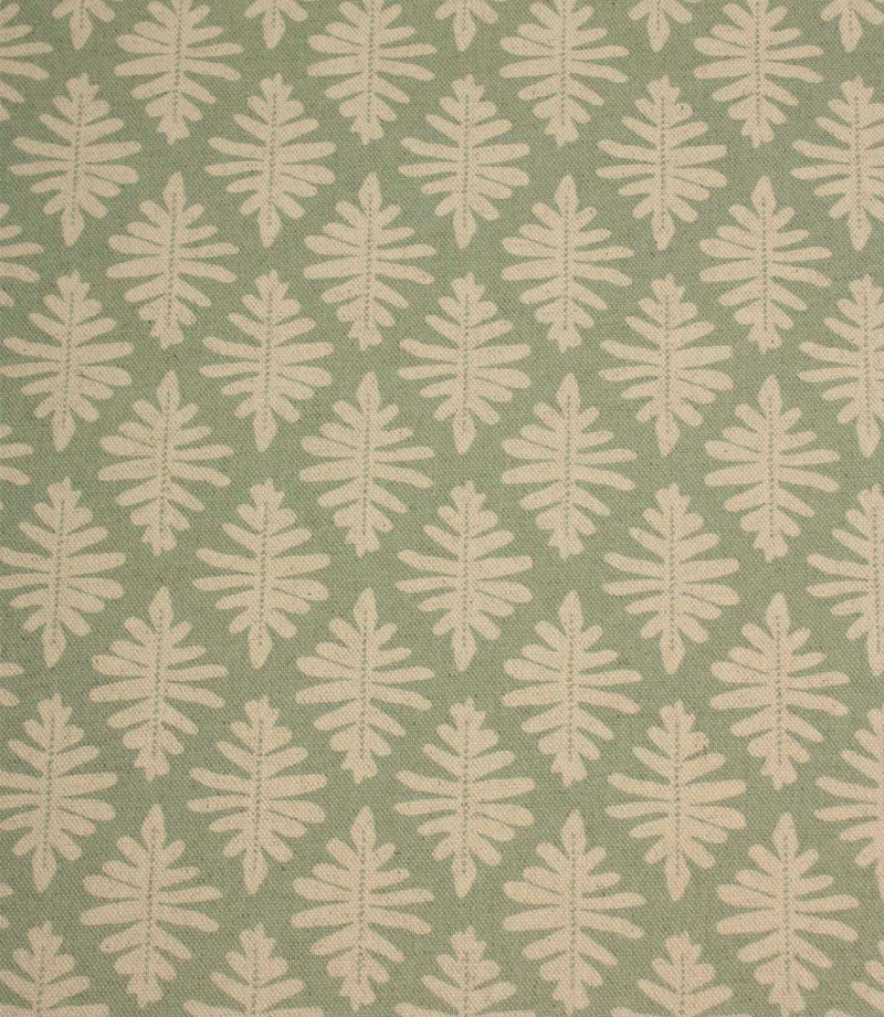Close-up of Ashleaf Dill fabric showcasing the woven texture and stylised cream leaf design.