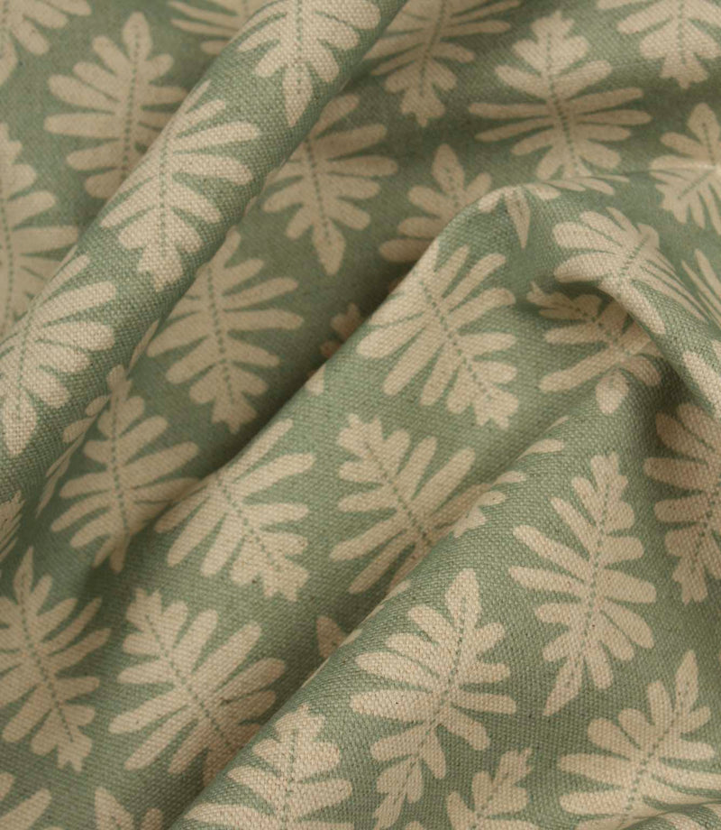 Draped Ashleaf Dill fabric showing the natural flow and soft sage green leaf pattern.