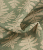 Detailed close-up of Ashleaf Dill fabric emphasising the woven texture and cream leaf design.