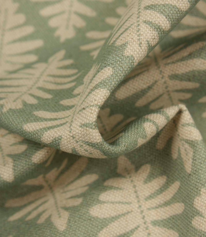 Detailed close-up of Ashleaf Dill fabric emphasising the woven texture and cream leaf design.