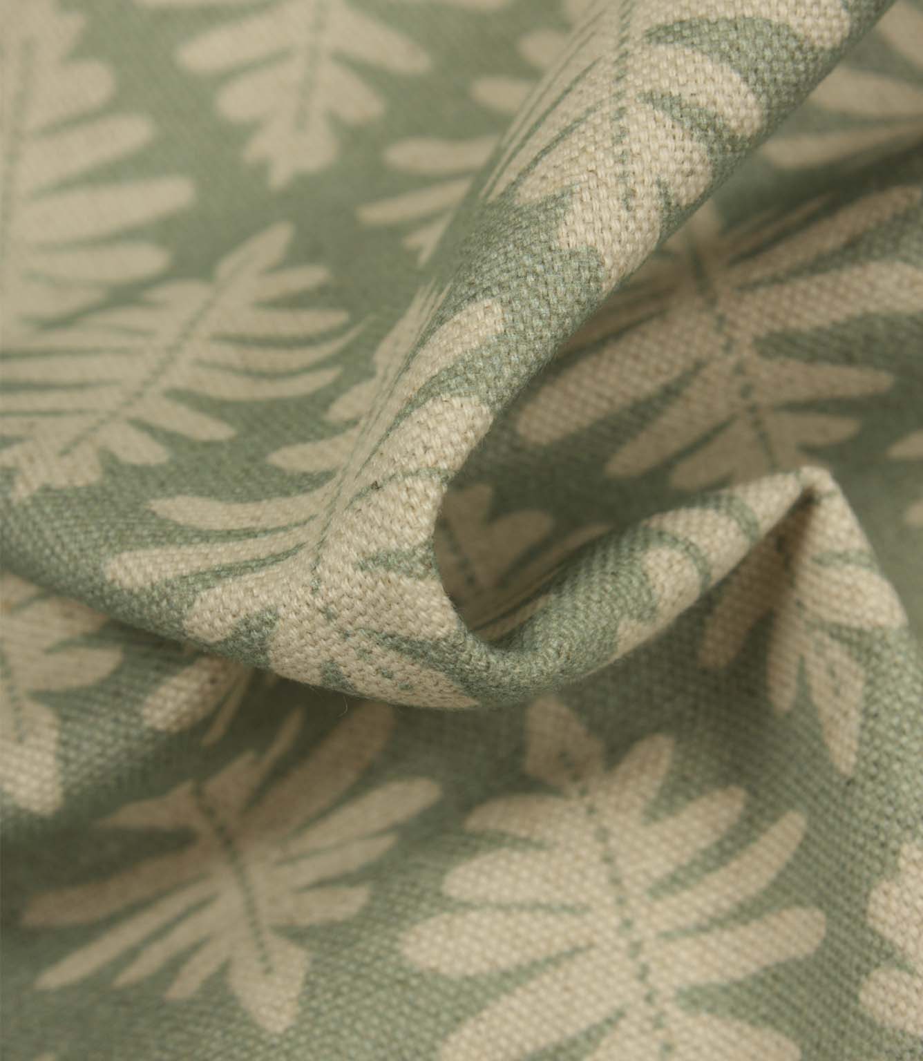 Detailed close-up of Ashleaf Dill fabric emphasising the woven texture and cream leaf design.