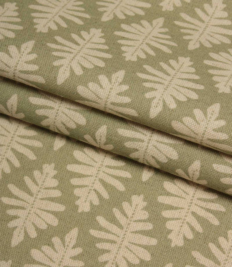 Folded Ashleaf Lemon Grass woven fabric highlighting the texture, drape and small-scale foliage design.