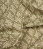 Draped Ashleaf Lemon Grass fabric displaying the repeating botanical pattern, ideal for curtains, blinds and cushions.