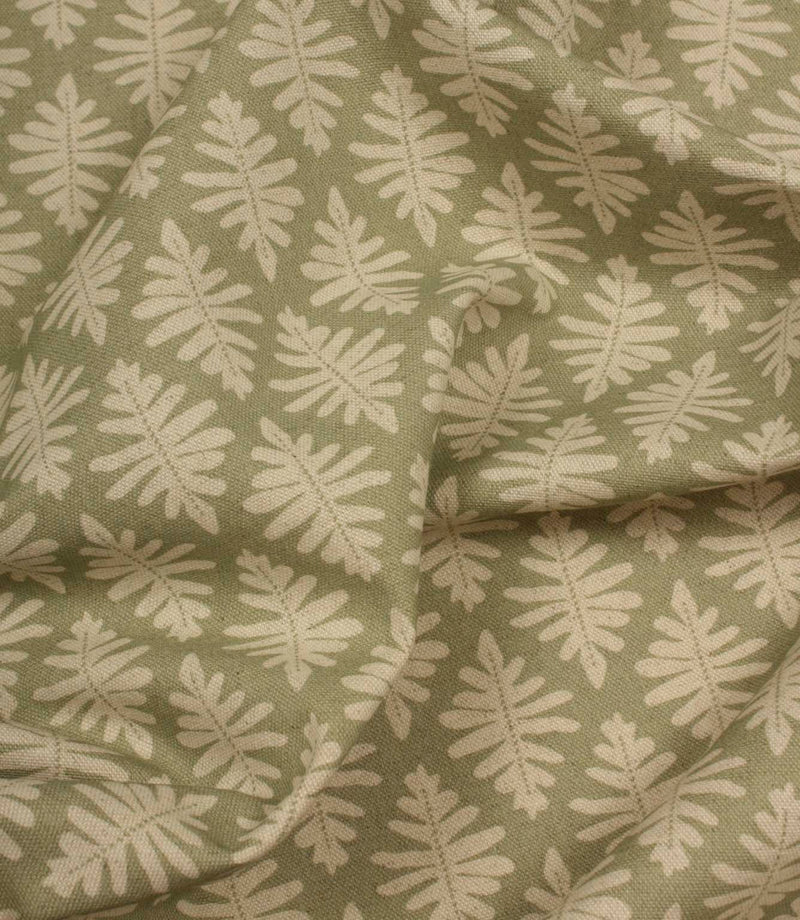 Draped Ashleaf Lemon Grass fabric displaying the repeating botanical pattern, ideal for curtains, blinds and cushions.