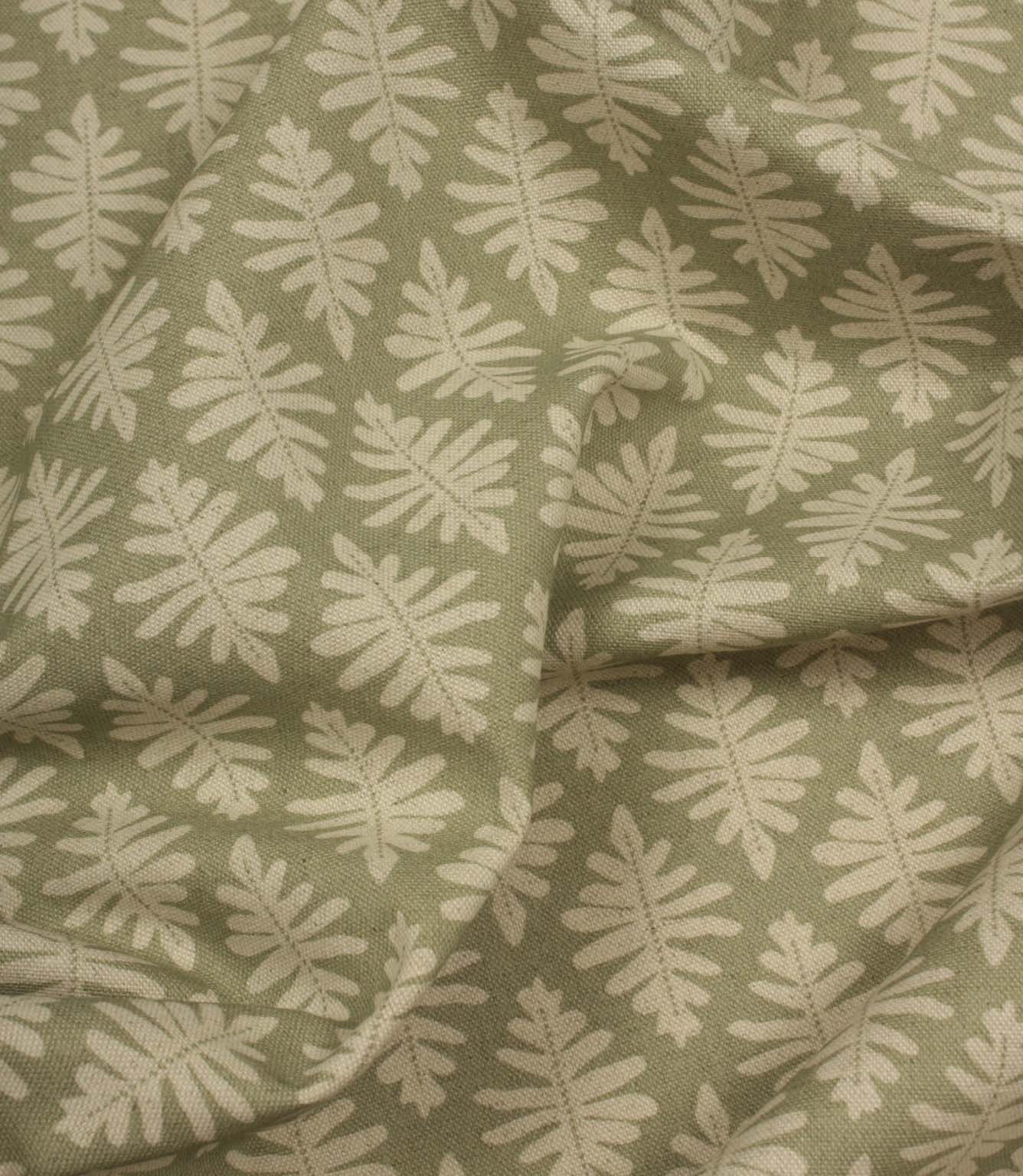 Draped Ashleaf Lemon Grass fabric displaying the repeating botanical pattern, ideal for curtains, blinds and cushions.