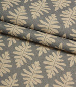 Folded Ashleaf Monsoon woven fabric highlighting the texture, drape and small-scale foliage design.