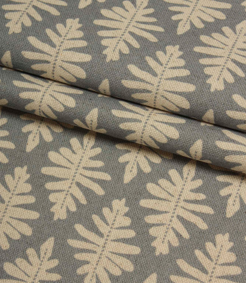 Folded Ashleaf Monsoon woven fabric highlighting the texture, drape and small-scale foliage design.