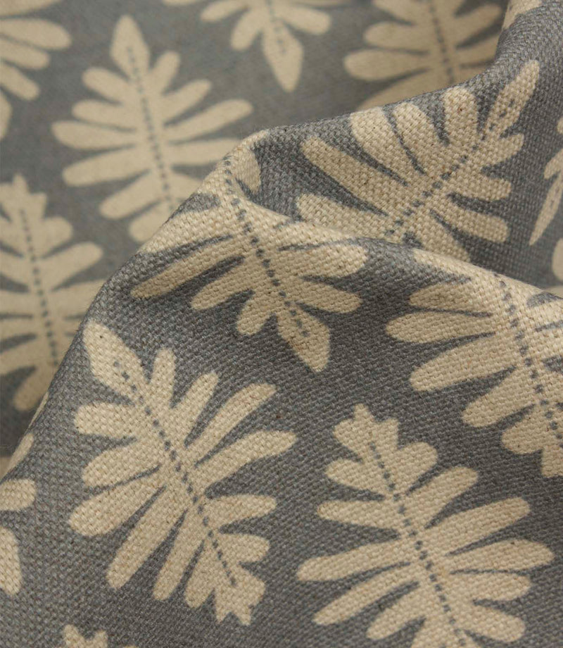 Close-up of Ashleaf Monsoon fabric showing the woven construction and stylised foliage detail.