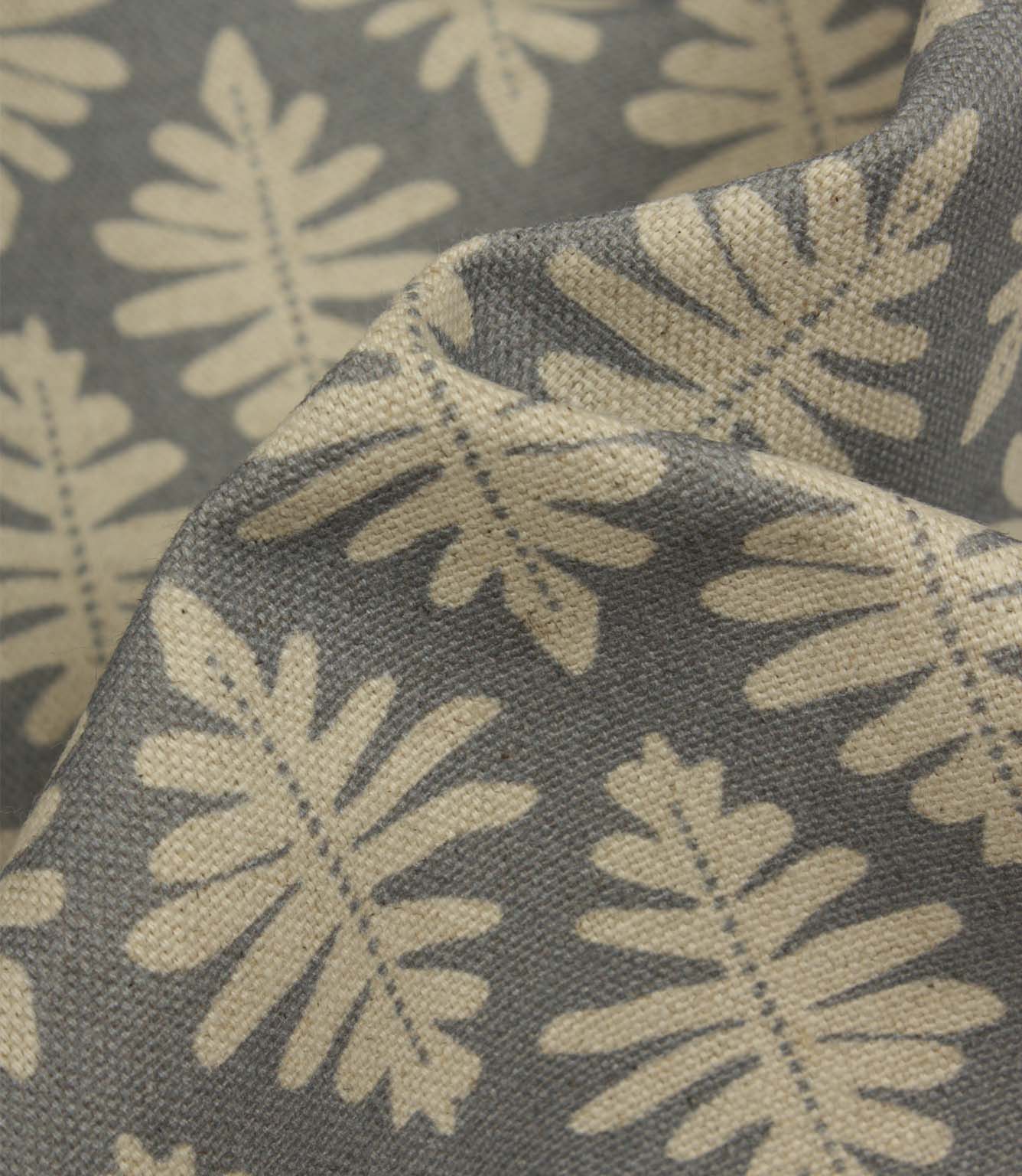Close-up of Ashleaf Monsoon fabric showing the woven construction and stylised foliage detail.
