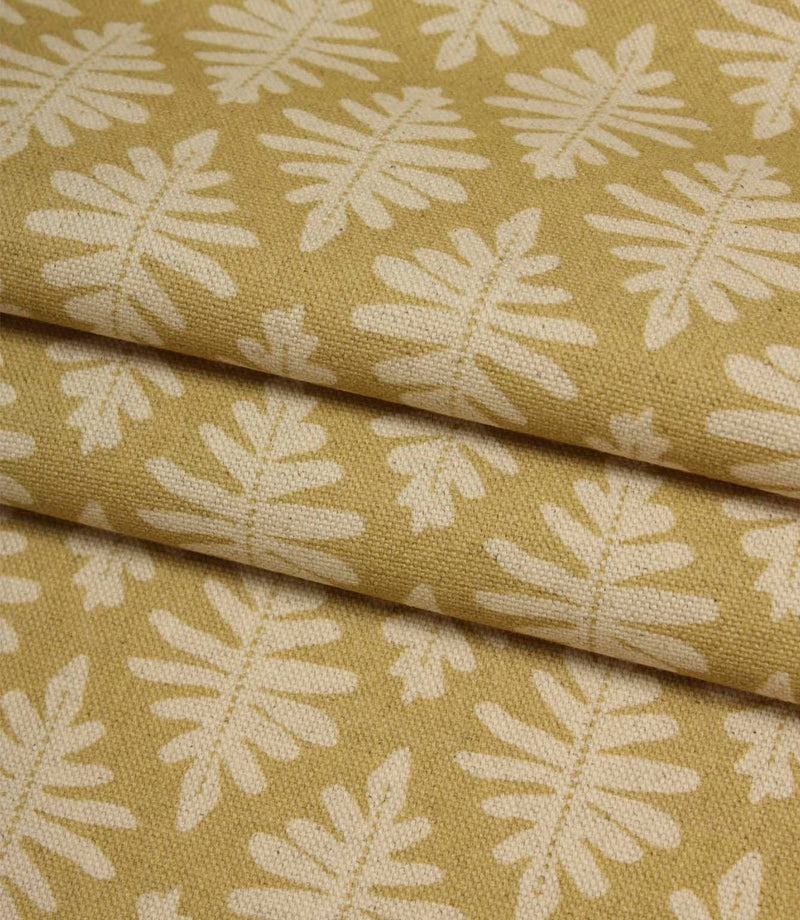 Folded Ashleaf Pesto woven fabric highlighting the texture, drape and small-scale foliage design.