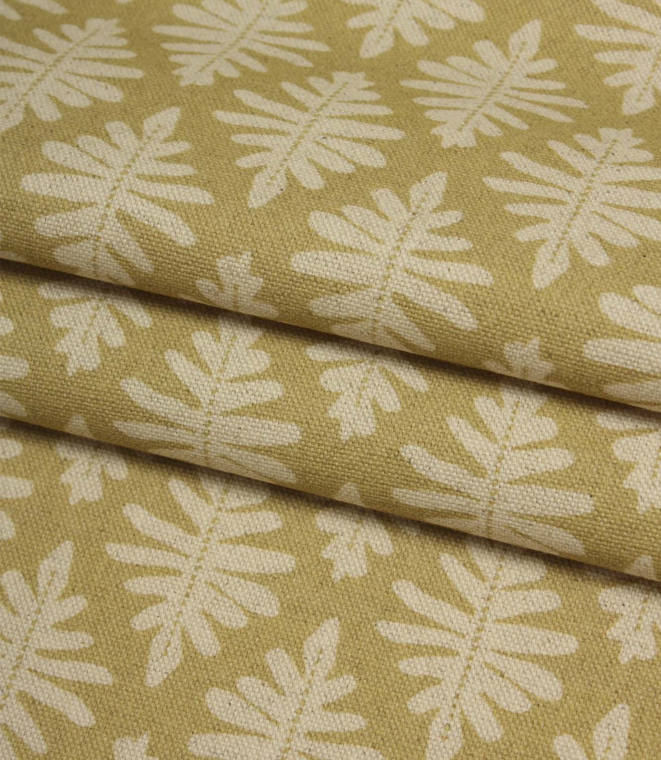 Folded Ashleaf Pesto woven fabric highlighting the texture, drape and small-scale foliage design.