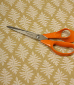 Ashleaf Pesto fabric shown with dressmaking scissors, illustrating the fabric's suitability for soft furnishing and craft projects.