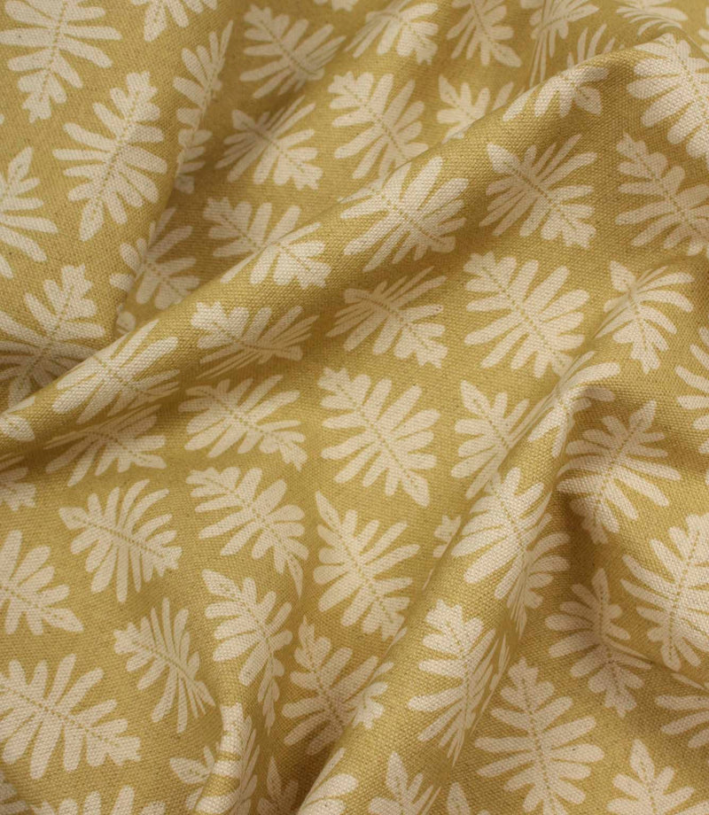 Draped Ashleaf Pesto fabric displaying the repeating botanical pattern and natural woven texture.