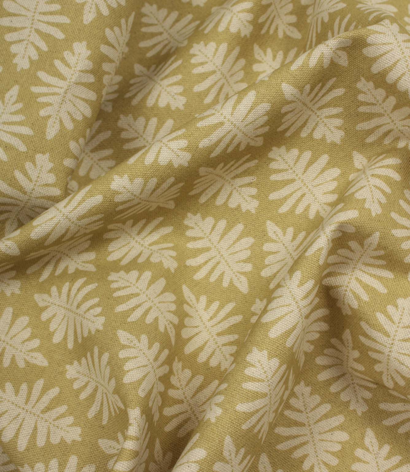 Draped Ashleaf Pesto fabric displaying the repeating botanical pattern and natural woven texture.