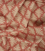 Draped Ashleaf Raspberry fabric illustrating the fabric's soft handle and repeating cream foliage pattern.