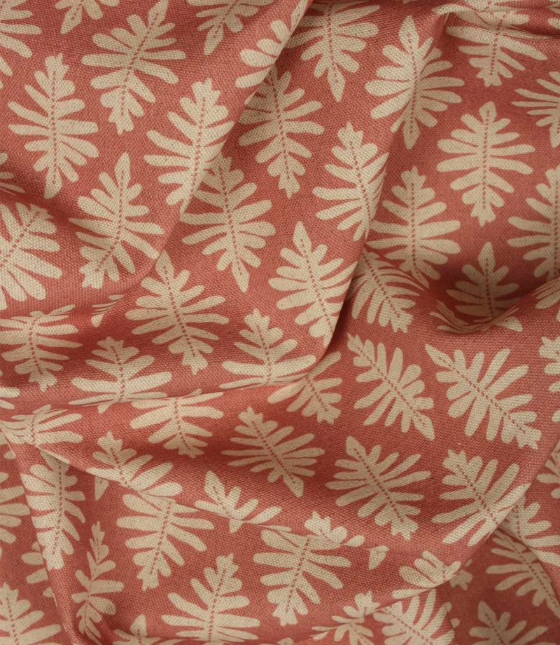 Draped Ashleaf Raspberry fabric illustrating the fabric's soft handle and repeating cream foliage pattern.