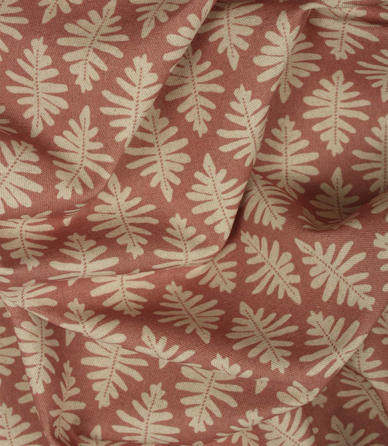 Draped Ashleaf Raspberry fabric illustrating the fabric's soft handle and repeating cream foliage pattern.