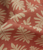Detailed close-up of Ashleaf Raspberry fabric highlighting the woven construction, texture and stylised leaf motif.