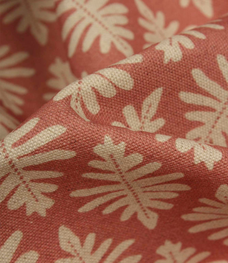 Detailed close-up of Ashleaf Raspberry fabric highlighting the woven construction, texture and stylised leaf motif.
