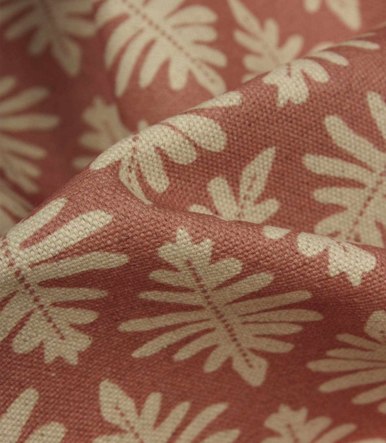 Detailed close-up of Ashleaf Raspberry fabric highlighting the woven construction, texture and stylised leaf motif.