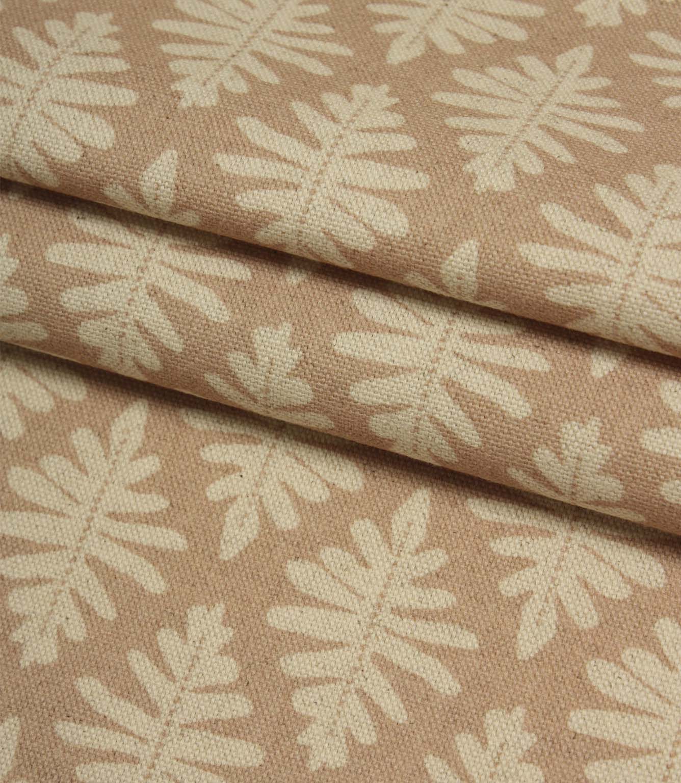 Folded Ashleaf Tuskan Pink fabric displaying the woven texture and contemporary cream leaf design.
