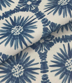Folded Atlantic Flower outdoor fabric featuring navy blue floral motifs on an off-white background with geometric detailing.