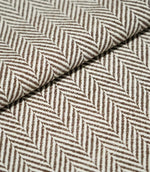 Close-up of folded Bampton Bison herringbone fabric, showing the substantial woven texture, fabric thickness and repeating brown and off-white chevron pattern.