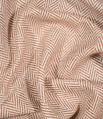 Bampton Chestnut herringbone fabric loosely draped and gathered, demonstrating its natural movement and distinctive chestnut orange and off-white woven pattern.