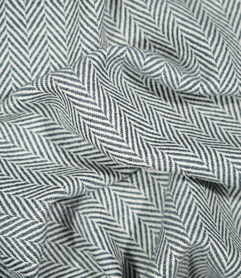 Bampton Ink herringbone fabric loosely draped and gathered, demonstrating its natural movement and bold repeating navy blue and off-white chevron design.