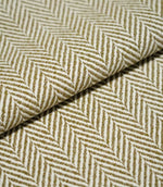 Close-up of folded Bampton Matcha herringbone fabric, showing the substantial woven texture, fabric thickness and repeating olive green and off-white chevron pattern.