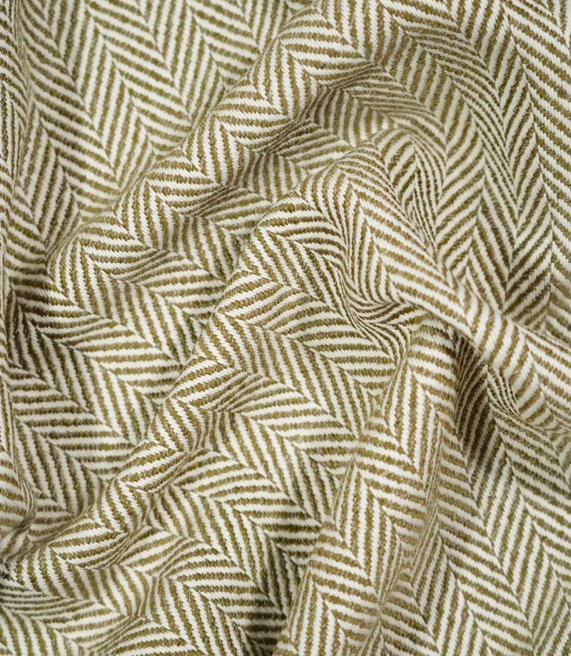 Bampton Matcha herringbone fabric loosely draped and gathered, demonstrating the natural movement of the material and its distinctive olive green and off-white chevron pattern.