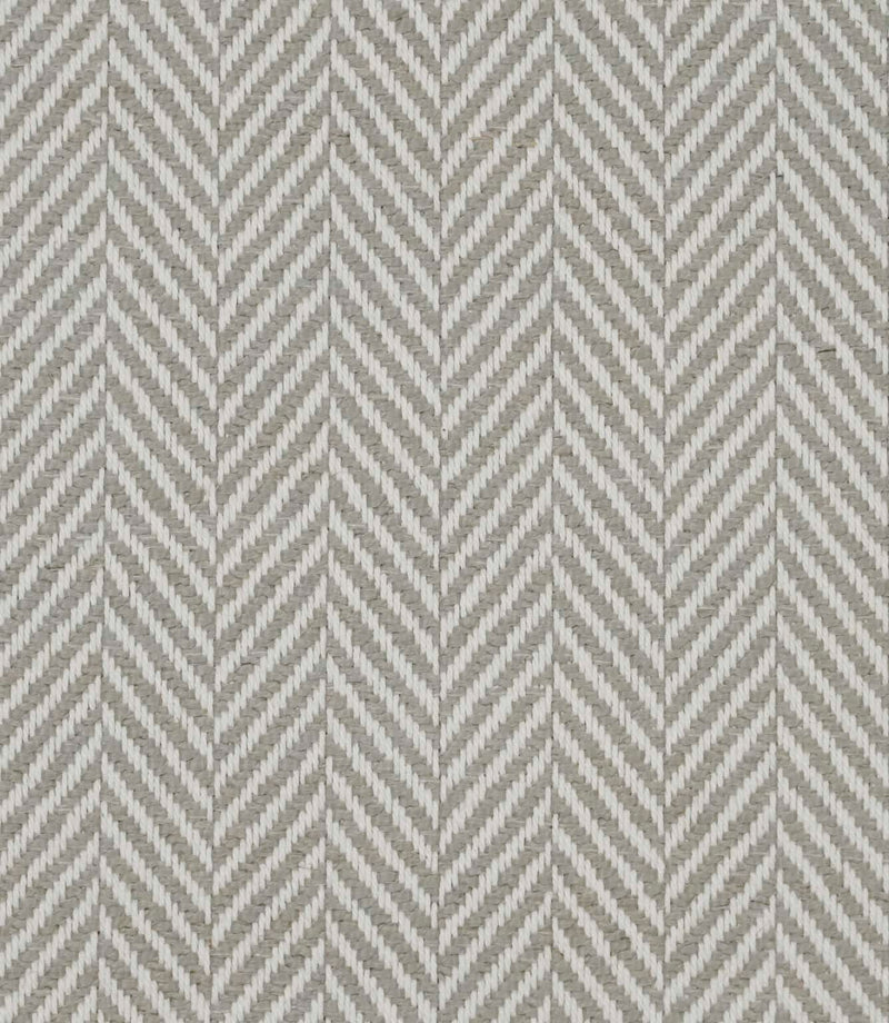 Close-up of Bampton Argent woven upholstery fabric showcasing the textured herringbone chevron weave in soft argent grey and ivory with a premium finish.