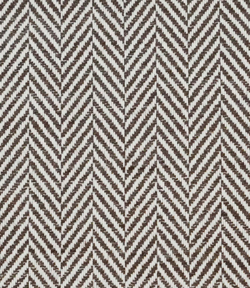 Close-up of Bampton Bison upholstery fabric highlighting the textured woven herringbone design and premium finish in brown and ivory.