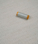 Bampton Elephant Grey woven herringbone upholstery fabric with matching light grey sewing thread, showcasing the textured chevron weave for upholstery and soft furnishing projects.