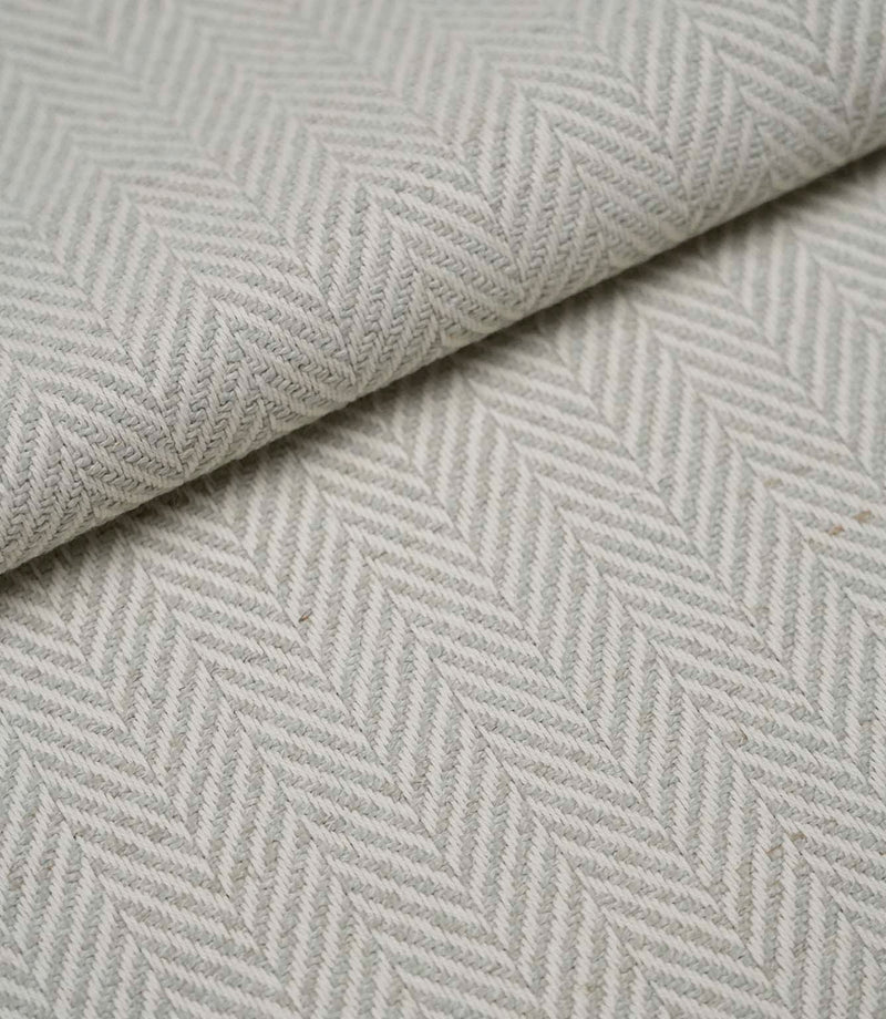 Folded Bampton Elephant Grey upholstery fabric displaying the woven herringbone chevron pattern and durable textured finish, ideal for curtains and upholstery.