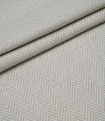 Layered Bampton Elephant Grey woven fabric featuring a subtle chevron herringbone design in elephant grey and ivory, perfect for upholstery and home décor projects.