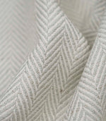 Macro close-up of Bampton Elephant Grey woven herringbone upholstery fabric showing the intricate chevron weave, textured finish and premium craftsmanship.