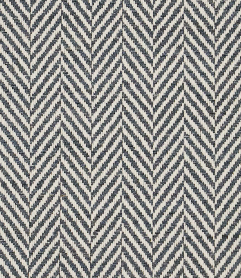 Close-up of Bampton Ink woven herringbone upholstery fabric featuring a classic chevron pattern in deep ink blue and ivory with a textured finish.