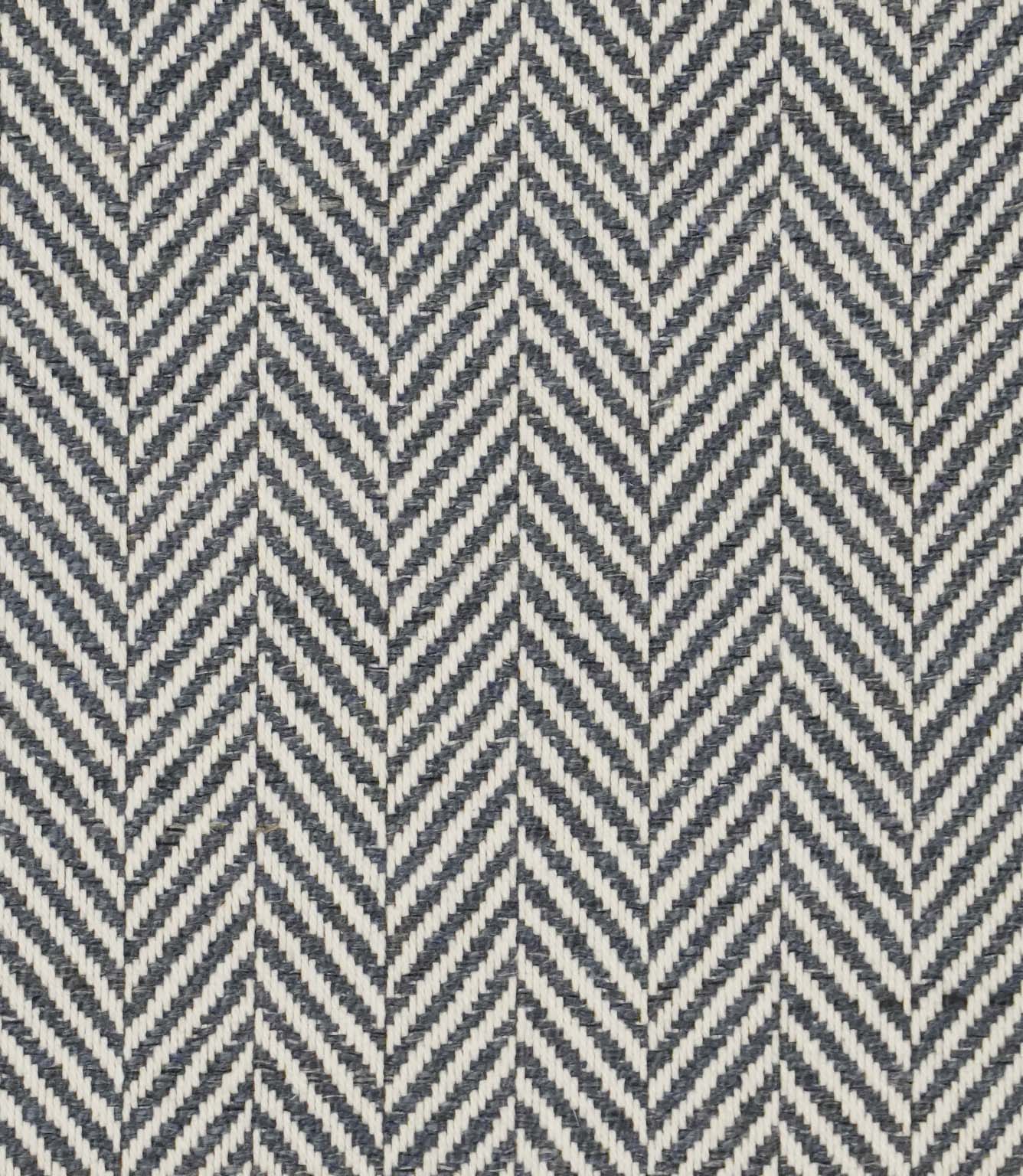 Close-up of Bampton Ink woven herringbone upholstery fabric featuring a classic chevron pattern in deep ink blue and ivory with a textured finish.