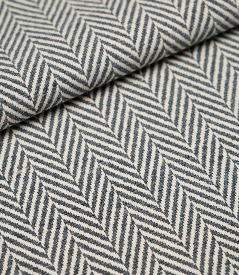 Folded Bampton Ink upholstery fabric showcasing the woven herringbone chevron pattern and durable textured finish, suitable for curtains and upholstery.