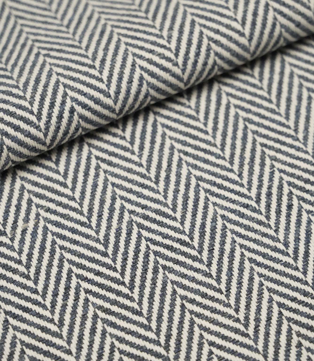 Folded Bampton Ink upholstery fabric showcasing the woven herringbone chevron pattern and durable textured finish, suitable for curtains and upholstery.