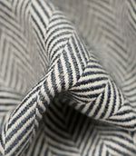 Macro close-up of Bampton Ink woven herringbone upholstery fabric highlighting the intricate chevron weave, rich texture and premium craftsmanship.