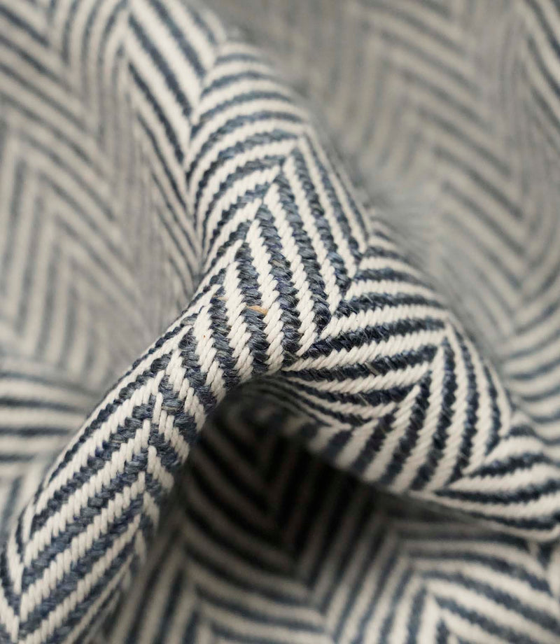 Macro close-up of Bampton Ink woven herringbone upholstery fabric highlighting the intricate chevron weave, rich texture and premium craftsmanship.